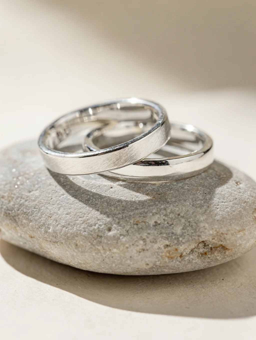 Hand-hammered 925 sterling silver rings on a stone surface
